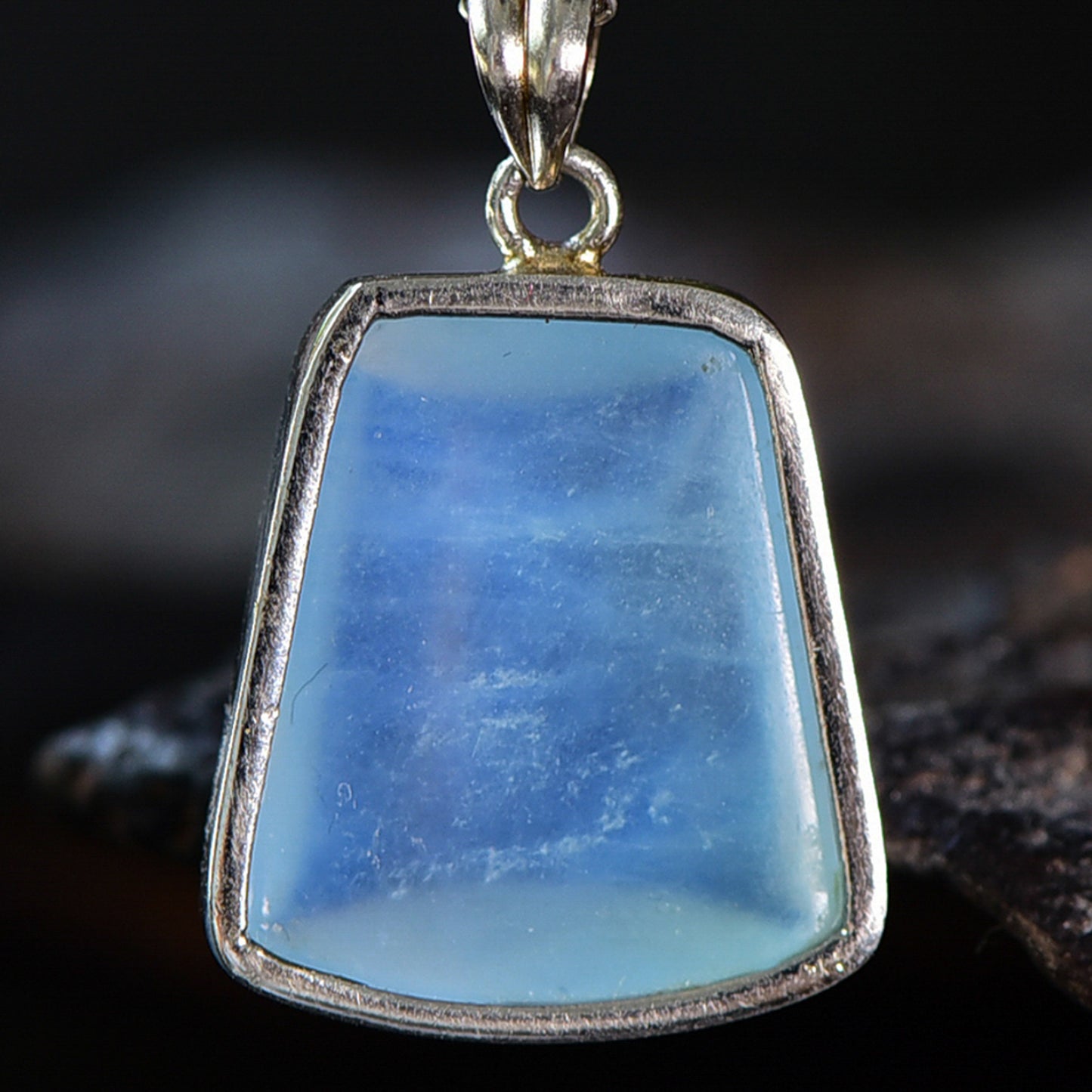 A natural aquamarine stone visible from the backside